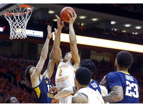 Tennessee forward Grant Williams (2) goes for a shot as he's defended by West Virginia guard Jermaine Haley (10) in the second half of an NCAA college basketball game Saturday, Jan. 26, 2019, in Knoxville, Tenn. Tennessee won 83-66.