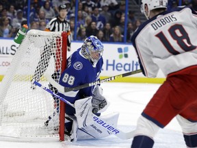 Tampa Bay Lightning goaltender Andrei Vasilevskiy (88) makes a save on a shot by Columbus Blue Jackets center Pierre-Luc Dubois (18) during the first period of an NHL hockey game Tuesday, Jan. 8, 2019, in Tampa, Fla.