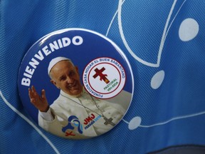 A pilgrim wears a pin of Pope Francis during a welcoming ceremony to open his participation in the church's World Youth Day festivities in Panama City, Thursday, Jan. 24, 2019.