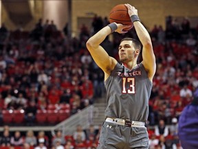 Texas Tech's Matt Mooney (13) shoots the ball for three points during the first half of an NCAA college basketball game against Kansas State, Saturday, Jan. 5, 2019, in Lubbock, Texas.
