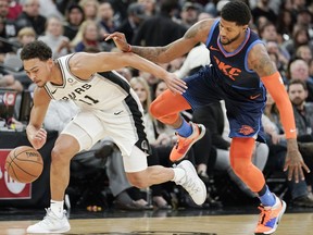 San Antonio Spurs' Bryn Forbes, left, and Oklahoma City Thunder's Paul George chase the ball during the first half of an NBA basketball game, Thursday, Jan. 10, 2019, in San Antonio.