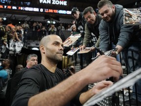 Charlotte Hornets guard Tony Parker, left, signs autographs for fans before an NBA basketball game against the San Antonio Spurs, Monday, Jan. 14, 2019, in San Antonio.