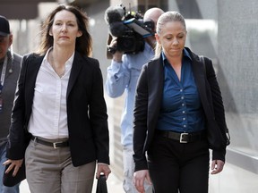 Former Dallas police officer Amber Guyger, right,  leaves the Frank Crowley Courts Building in downtown Dallas, after making her first court appearance, Tuesday, Jan. 8, 2019. Guyger is charged in the Sept. 6, 2018 fatal shooting of  Botham Jean, her unarmed black neighbor,  whose apartment she says she mistook as her own.