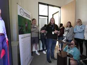 Amy Frake, center, explains to students, from Westchester Academy for International Studies, how to ask a question to Holocaust survivor William Morgan using an interactive virtual conversation exhibit at the the Holocaust Museum Houston Friday, Jan. 11, 2019, in Houston. The University of Southern California Shoah Foundation has recorded 18 interactive testimonies with Holocaust survivors over the last several years.