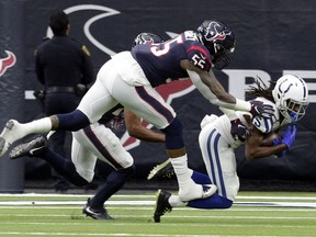 Indianapolis Colts wide receiver T.Y. Hilton (13) pulls in a catch in front of Houston Texans inside linebacker Benardrick McKinney (55) during the first half of an NFL wild card playoff football game, Saturday, Jan. 5, 2019, in Houston.