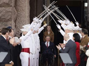 Texas Gov. Greg Abbott, front center, arrives for his inauguration ceremony with his daughter, Audrey, in Austin, Texas, Tuesday, Jan. 15, 2019.