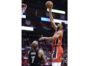 New Orleans Pelicans center Jahlil Okafor, right, shoots over Houston Rockets forward PJ Tucker during the first half of an NBA basketball game Tuesday, Jan. 29, 2019, in Houston.