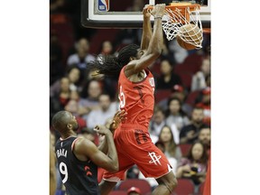 Houston Rockets forward Kenneth Faried, right, dunks as Toronto Raptors center Serge Ibaka watches during the first half of an NBA basketball game, Friday, Jan. 25, 2019, in Houston.