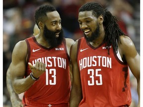 Houston Rockets guard James Harden (13) talks with forward Kenneth Faried late in the second half of an NBA basketball game against the Toronto Raptors, Friday, Jan. 25, 2019, in Houston.