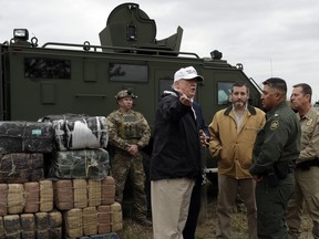 President Donald Trump tours the U.S. border with Mexico at the Rio Grande on the southern border, Thursday, Jan. 10, 2019, in McAllen, Texas.