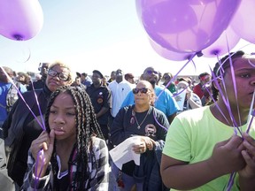 Zyriah Taylor, 11, left, and her cousin, Jaskya Lee-Mills, 13, attend a community rally for seven-year-old Jazmine Barnes on Saturday, Jan. 5, 2019 in Houston.   Barnes was killed when a driver shot into the car she and her family were driving in last Sunday.