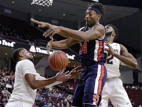 Auburn forward Anfernee McLemore (24) battles for a rebound between Texas A&M guard Savion Flagg, left, and forward Josh Nebo (32) during the first half of an NCAA college basketball game, Wednesday, Jan. 16, 2019, in College Station, Texas.