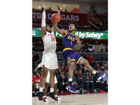East Carolina forward Jayden Gardner (1) puts up a shot past Houston forward Breaon Brady (24) during the first half of an NCAA college basketball game Wednesday, Jan. 23, 2019, in Houston.