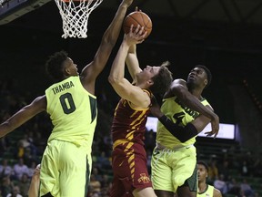 Baylor forward Flo Thamba, left, blocks the shot of Iowa State forward Michael Jacobson, center, as guard Mario Kegler, right, helps defend during the first half of an NCAA college basketball game Tuesday, Jan. 8, 2019, in Waco, Texas.