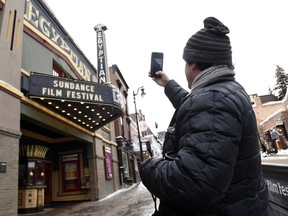 Matt Arnett of Atlanta, Ga, producer of the Sundance Film Festival narrative short "I Snuck Off the Slave Ship," takes a picture of the Egyptian Theatre marquee on the first day of the 2019 Sundance Film Festival, Thursday, Jan. 24, 2019, in Park City, Utah. The annual film festival runs through February 3.