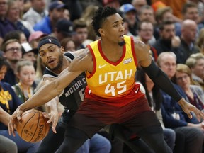 Detroit Pistons guard Bruce Brown, left, attempts a steal from Utah Jazz guard Donovan Mitchell (45) during the first half of an NBA basketball game Monday, Jan. 14, 2019, in Salt Lake City.