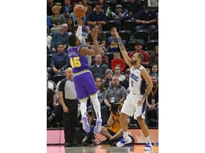 Utah Jazz guard Donovan Mitchell (45) shoots as Orlando Magic guard Evan Fournier (10) defends during the first half of an NBA basketball game Wednesday, Jan. 9, 2019, in Salt Lake City.