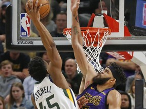 Utah Jazz guard Donovan Mitchell (45) dunks on Los Angeles Lakers center JaVale McGee (7) during the first half of an NBA basketball game Friday, Jan. 11, 2019, in Salt Lake City.