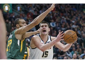 Utah Jazz center Rudy Gobert (27) defends against Denver Nuggets center Nikola Jokic (15) during the first half of an NBA basketball game Wednesday, Jan. 23, 2019, in Salt Lake City.