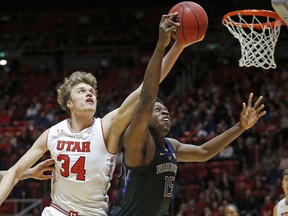 Washington forward Noah Dickerson (15) and Utah center Jayce Johnson (34) battle for a rebound during the first half of an NCAA college basketball game Thursday, Jan., 10, 2019, in Salt Lake City.