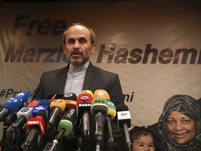 Paiman Jebeli, deputy chief of Iran's state IRIB broadcaster gives a press briefing about American-born news anchor on Iranian state television's English-language service, Marzieh Hashemi, shown in banner, in Tehran, Iran, Wednesday, Jan. 16, 2019. Hashemi has been arrested after flying into the U.S., the broadcaster reported Wednesday. The reported detention of Press TV's Hashemi, born Melanie Franklin of New Orleans, comes as Iran faces increasing criticism of its own arrests of dual nationals and others with Western ties, previously used as bargaining chips in negotiations with world powers.