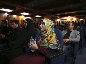 A woman weeps while a video clip is shown about an American-born news anchor working for Iranian state television's English-language service, Marzieh Hashemi, during a press briefing by Paiman Jebeli, deputy chief of Iran's state IRIB broadcaster, in Tehran, Iran, Wednesday, Jan. 16, 2019. Hashemi has been arrested after flying into the U.S., the broadcaster reported Wednesday. The reported detention of Press TV's Hashemi, born Melanie Franklin of New Orleans, comes as Iran faces increasing criticism of its own arrests of dual nationals and others with Western ties.