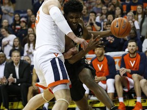 Wake Forest forward Jaylen Hoard, right, tries to get past Virginia center Jack Salt (33) during the first half of an NCAA college basketball game in Charlottesville, Va., Tuesday, Jan. 22, 2019.