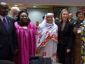 Sudan's Commissioner for Social Affairs Amira Al-Fadil, center, poses with European Union foreign policy chief Federica Mogherini, second right, and other attendees at the start of an EU-African Union meeting at the Europa building in Brussels, Tuesday, Jan. 22. 2019.