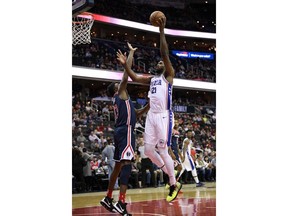 Philadelphia 76ers center Joel Embiid (21) goes to the basket against Washington Wizards center Thomas Bryant (13) during the first half of an NBA basketball game, Wednesday, Jan. 9, 2019, in Washington.