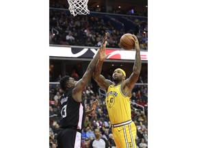 Golden State Warriors center DeMarcus Cousins (0) goes to the basket against Washington Wizards center Thomas Bryant (13) during the first half of an NBA basketball game Thursday, Jan. 24, 2019, in Washington.