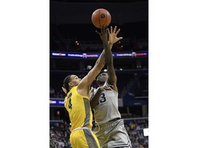 Georgetown forward Josh LeBlanc, right, goes to the basket against Marquette forward Theo John (4) during the second half of an NCAA college basketball game, Tuesday, Jan. 15, 2019, in Washington. Marquette won 74-71.