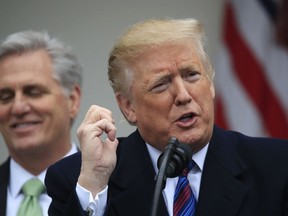 President Donald Trump joined by House Minority Leader Kevin McCarthy of Calif., and other Congressional Republican leaders, gestures like he is talking on a phone during a news conference in the Rose Garden of the White House in Washington, after a meeting with Congressional leaders on border security, as the government shutdown continues Friday, Jan. 4, 2019.