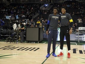 Milwaukee Bucks' Giannis Antetokounmpo, right, and Dallas Mavericks' Kostas Antetokounmpo, left, pose for a photo before an NBA basketball game Monday, Jan. 21, 2019, in Milwaukee.