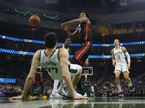 Miami Heat's Hassan Whiteside is called for a charge on Milwaukee Bucks' Ersan Ilyasova during the first half of an NBA basketball game Tuesday, Jan. 15, 2019, in Milwaukee.