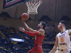 Texas Tech guard Davide Moretti (25) drives while defended by West Virginia guard Jordan McCabe (5) during the first half of an NCAA college basketball game Wednesday, Jan. 2, 2019, in Morgantown, W.Va.