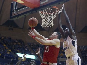 Texas Tech guard Matt Mooney (13) drives to the basket while defended by West Virginia forward Wesley Harris (21) during the first half of an NCAA college basketball game Wednesday, Jan. 2, 2019, in Morgantown, W.Va.