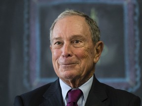 FILE - In this Nov. 30, 2018 file photo, former New York Mayor Michael Bloomberg speaks with members of the media at The Bridge Way School in Philadelphia. Bloomberg says that if he runs for president, he'll pay for it himself, defending candidates who use personal riches to bankroll campaigns even as another top 2020 contender, Massachusetts Sen. Elizabeth Warren, has decried the Democratic White House nomination becoming "one more plaything that billionaires can buy."