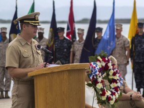 FILE - In this June 3, 2014, image provided by the U.S. Navy, Navy Capt. John R. Nettleton, then-commanding officer of Naval Station Guantanamo Bay, Cuba, speaks during a Battle of Midway commemoration ceremony. Nettleton was arrested Wednesday, Jan. 9, 2018, on charges that he interfered with the investigation into the death of a civilian with whom he fought after an argument over whether the officer had had an affair with the man's wife.