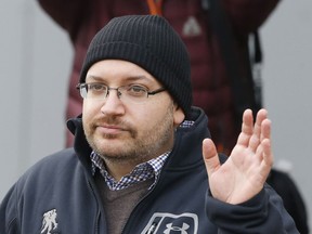 FILE - In this Jan. 20, 2016, file photo, Washington Post reporter Jason Rezaian waves at Landstuhl Regional Medical Center in Landstuhl, Germany. Rezaian says he was arrested by Iranian authorities, subjected to a sham trial and held for 18 months purely as a way to gain leverage over the American government in nuclear negotiations. Rezaian, 43, testified Tuesday, Jan. 8, 2019, in federal court as part of a multi-million dollar lawsuit against the Islamic Republic.