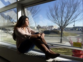 FILE - In this Feb. 2, 2016, file photo, Naila Amin, 26, looks out from a classroom window at Nassau Community College in Garden City, N.Y. According to data provided to The Associated Press, the U.S. approved thousands of requests by men to bring child and teenage brides from another country. "My passport ruined my life," said Naila Amin, a dual citizen from Pakistan who grew up in New York City. She was forcibly married at 13 in Pakistan and applied for papers for her 26-year-old husband to come to the country. "People die to come to America. I was a passport to him. They all wanted him here, and that was the way to do it."