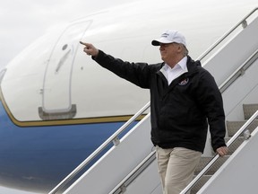 In this Jan. 10, 2019, photo, President Donald Trump gestures after arriving at McAllen International Airport for a visit to the southern border in McAllen, Texas. Trump scrapped a trip to Switzerland later this month, citing the partial government shutdown. But he did jet this week to the southwestern border to continue pressing for a border wall, the issue that forced the shutdown in the first place, and he plans to give a speech to farmers Monday in New Orleans.