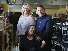 In this image provided by Karen Pulfer Focht, Doug Ketchum and his wife Mary pose with their daughter Stacie as their Memphis liquor store, Kimbrough Wine & Spirits. The U.S. Supreme Court is set to hear a dispute over Tennessee's residency requirements for liquor store owners. Doug and Mary Ketchum moved from Utah to Memphis and say Tennessee makes it almost impossible for someone to break into the liquor business from out of state.