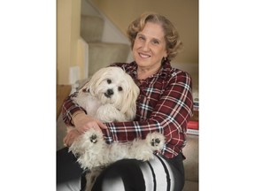 Mary Radnofsky, diagnosed with a rare form of leukoencephalopathy and in the early stages of dementia, holds her service dog Benjy at her home, on Friday, Jan. 18, 2019, in Alexandria, Va. Faced with an aging American workforce, U.S. companies are increasingly navigating delicate conversations with employees suffering from cognitive declines or dementia diagnoses, experts say.