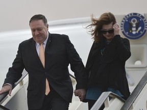 Secretary of State Mike Pompeo and his wife Susan disembark from their aircraft as they arrive in Amman, Jordan at the start of a Middle East tour, Tuesday, Jan. 8, 2019.