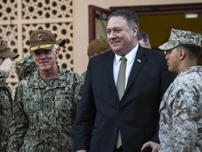 U.S. Secretary of State Mike Pompeo, center walks with Vice Adm. James Malloy, commander of the U.S. Naval Forces Central Command/5th Fleet, after a tour of the U.S. Naval Forces Central Command center in Manama, Bahrain, Friday, Jan. 11, 2019.