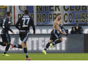 Lazio's Ciro Immobile, right, celebrates after scoring his side's opening goal during an Italian Cup quarterfinal soccer match between Inter Milan and Lazio at the San Siro stadium, in Milan, Italy, Thursday, Jan. 31, 2019.