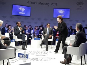 Singer and co-founder of RED Bono, 2nd right, gestures to Afsaneh Mashayekhi Beschloss, founder of RockCreek, Christine Lagarde, Managing Director of IMF and Rwanda President Paul Kagame, from left, as he arrives for the "Closing the Financing Gap" session at the annual meeting of the World Economic Forum in Davos, Switzerland, Wednesday, Jan. 23, 2019.