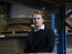 Charlie Pool, the CEO of Stowga, poses for a portrait in the Lovespace warehouse in Dunstable, England, Monday, Jan. 14, 2019. Lovespace, which collects boxes from customers, stores them and then returns the goods when needed, says revenue from businesses doubled over the past year as enterprises large and small began stockpiling inventory because of concerns they will be cut off from suppliers if Britain leaves the European Union without an agreement on future trading relations.