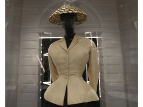 A Bar Suit and Hat made from silk, wool taffeta and straw, design by Christian Dior, Haute couture Spring/Summer 1947, on display during a press preview of the largest exhibition in the United Kingdom of the Paris based fashion House of Dior at the V&A Museum in London, Wednesday, Jan. 30, 2019. Billed as the largest and most comprehensive exhibition ever staged in Britain on the revered fashion house, the exhibition traces the impact of Dior over seven decades and showcases dozens of spectacular couture gowns.