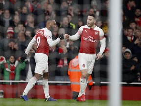 Arsenal's Alexandre Lacazette, left, with teammate Arsenal's Sead Kolasinac celebrates after scoring the opening goal of the during the English Premier League soccer match between Arsenal and Chelsea at the Emirates stadium in London, Saturday, Jan. 19, 2019.